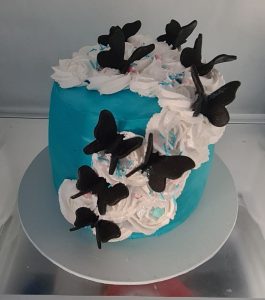 Blue birthday cake with black butterflies