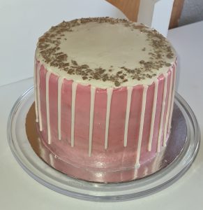 Pink with white chocolate drip birthday cake