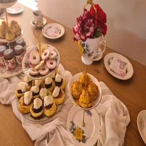Sugar cookies and assorted scones with jams and whipped cream