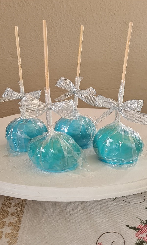 Blue toffee apples with silver bow