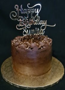 Chocolate celebration birthday cake with custom cake topper