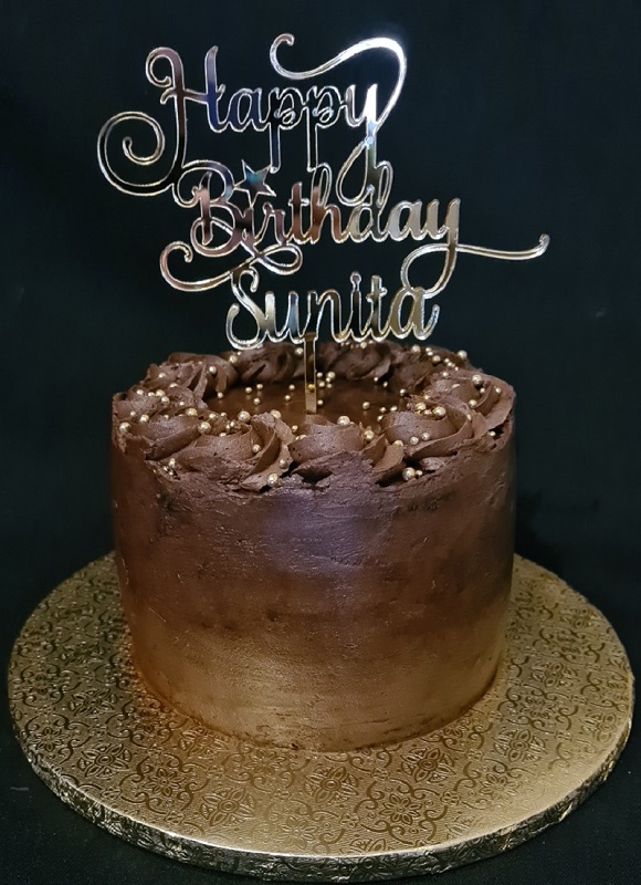 Chocolate celebration birthday cake with custom cake topper
