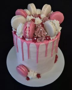 Pastel Pink birthday cake with chocolate drip and macaroon decoration